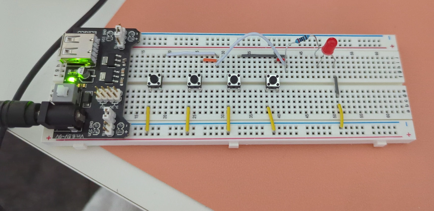 Breadboard of electronics for 4 buttons turning on one LED
